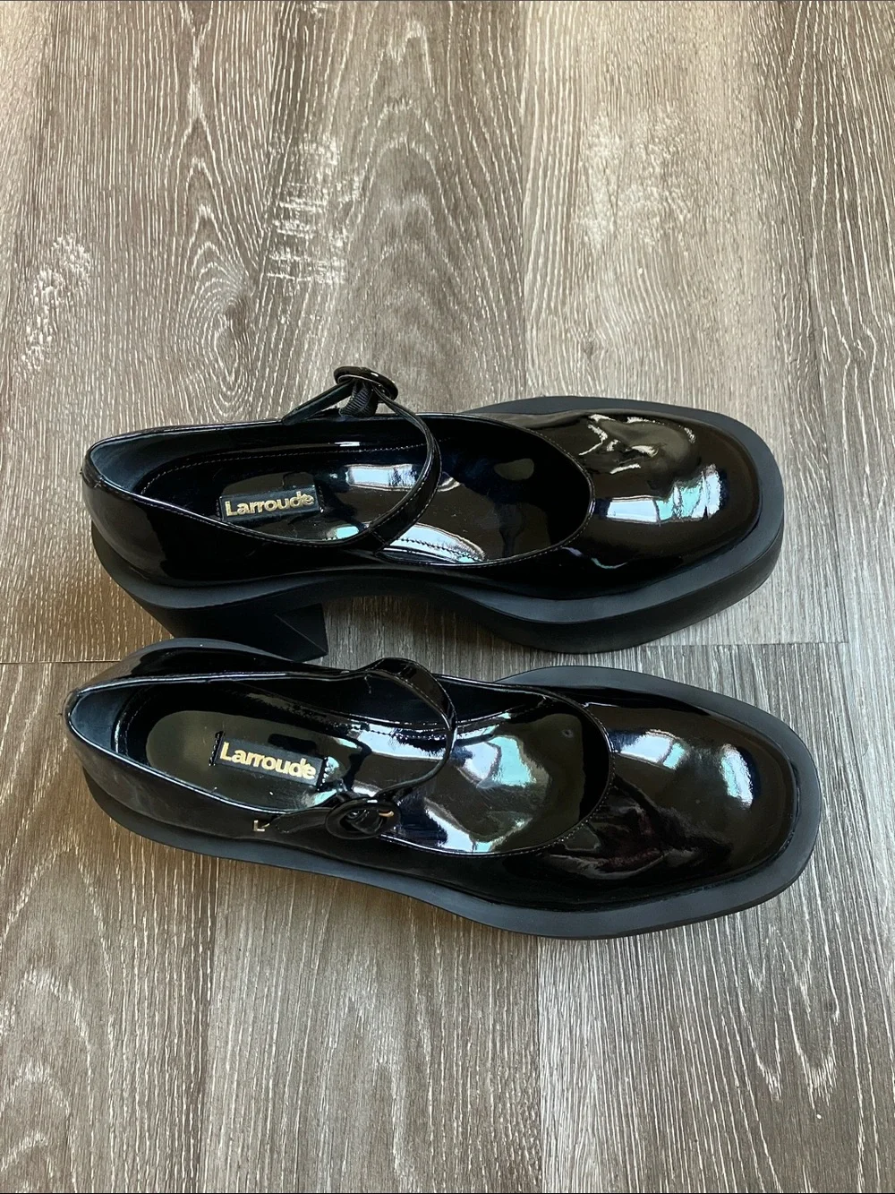 Larroude Olivia Platform Pumps in glossy black patent leather.